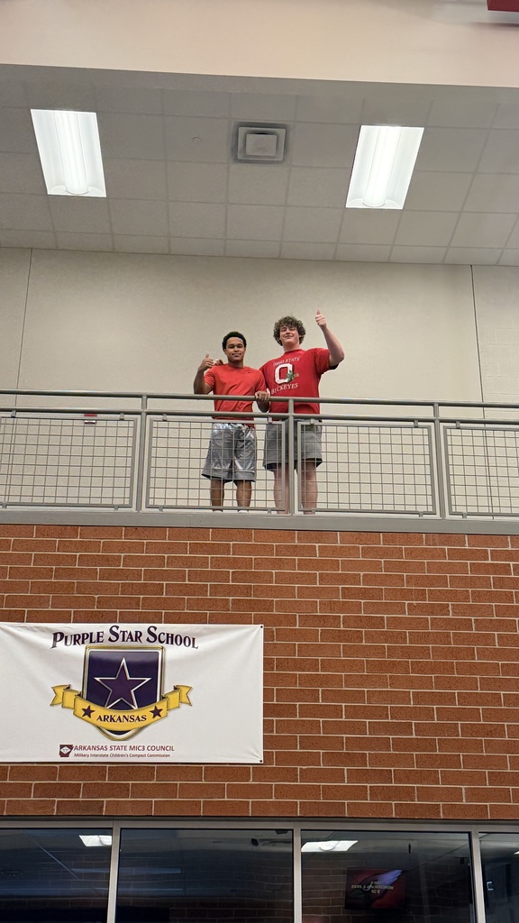 student launching airplane