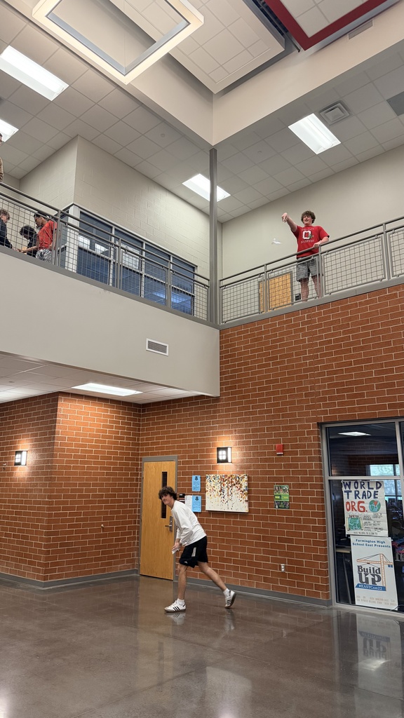 student launching airplane