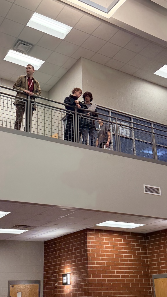 student launching airplane