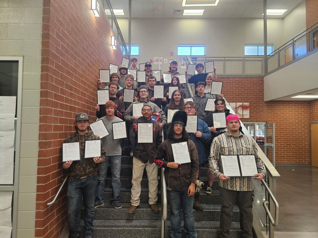 students posing with certificates