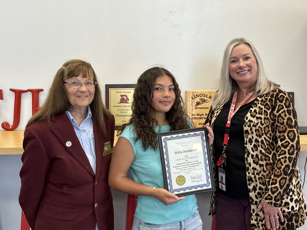 Riley Sundquist holding certificate award