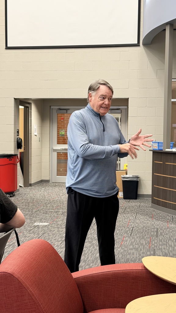 Houston speaking to students in library