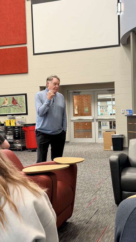 Houston speaking to students in library