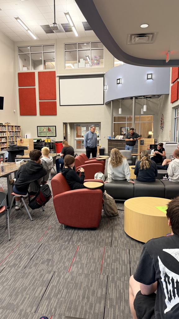 Houston speaking to students in library