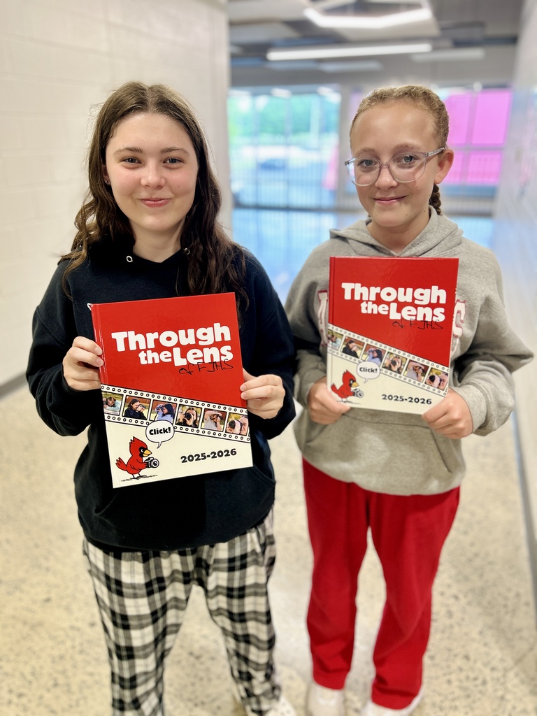 Students holding yearbooks
