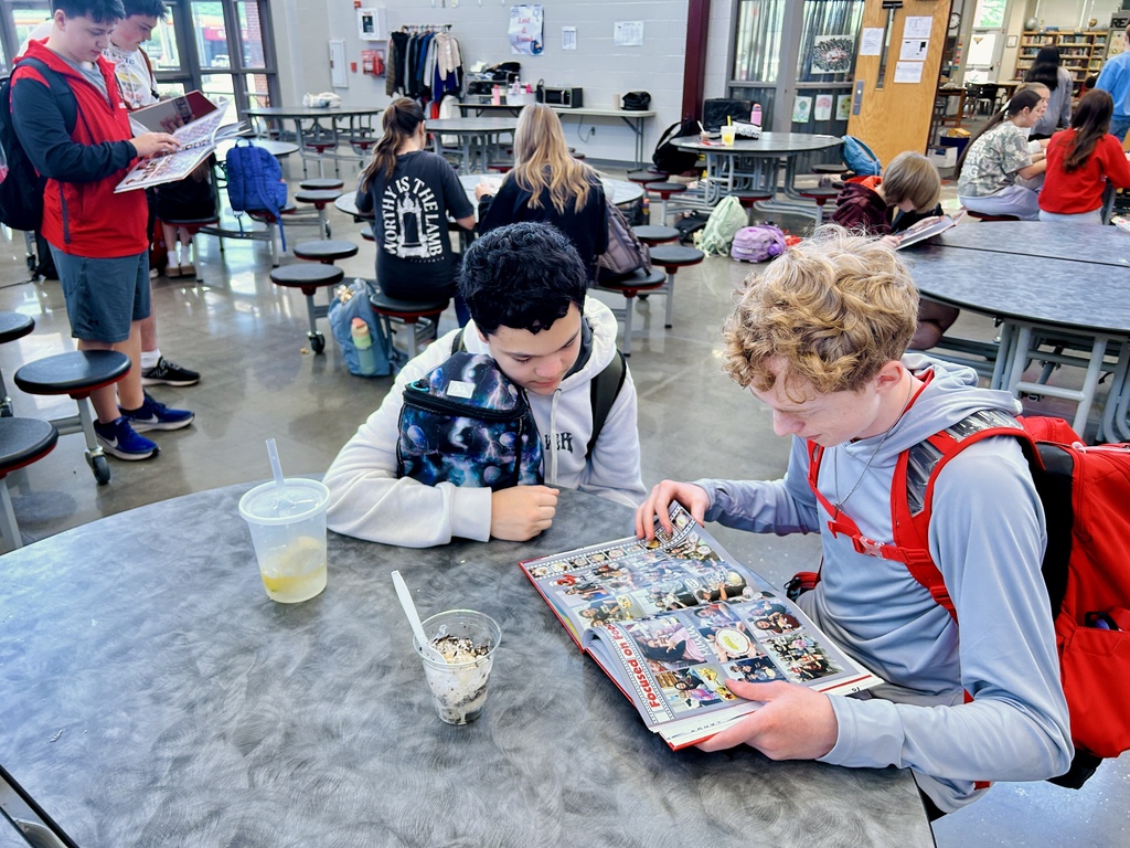 Students looking at yearbook