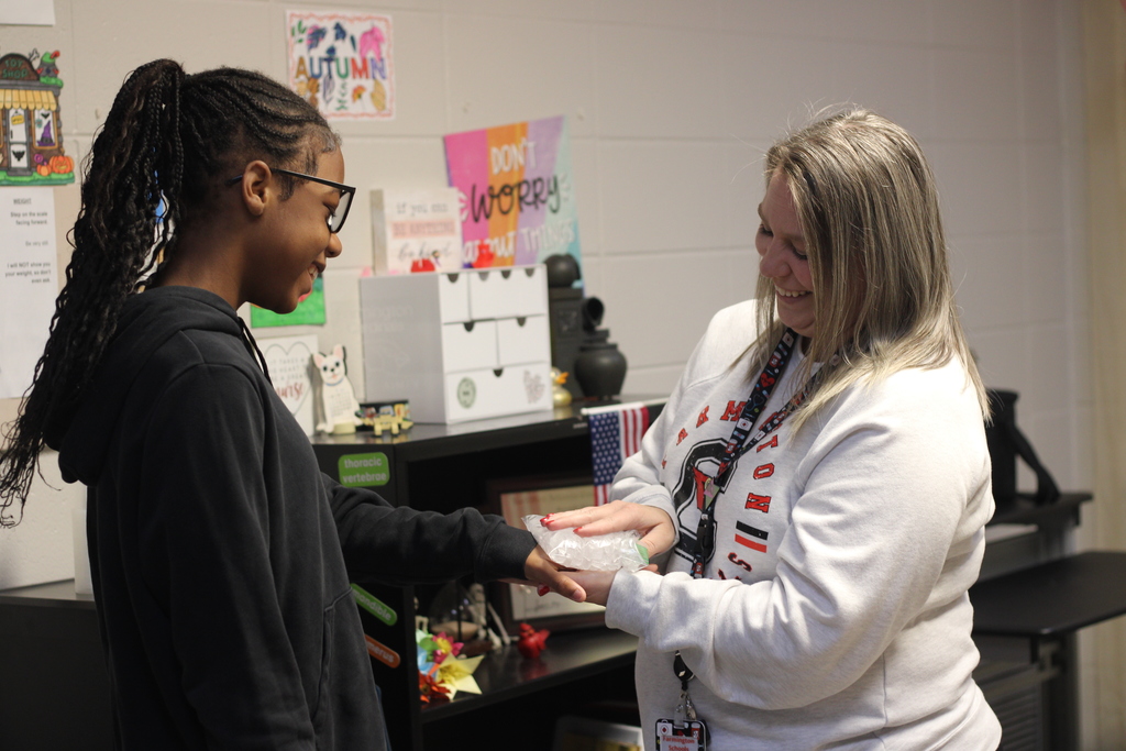 Nurse helping student with ice pack.