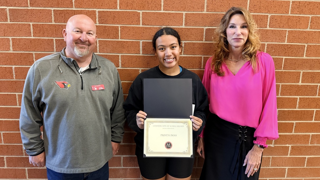student posing with faculty and award