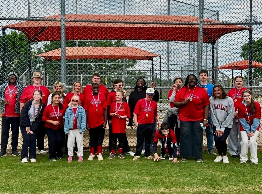 students and players posing with medals