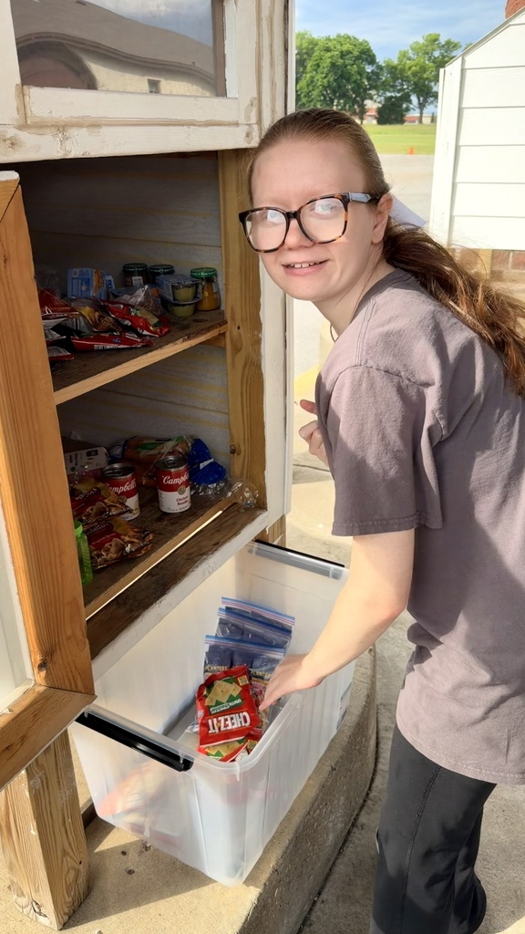 student stocking pantry