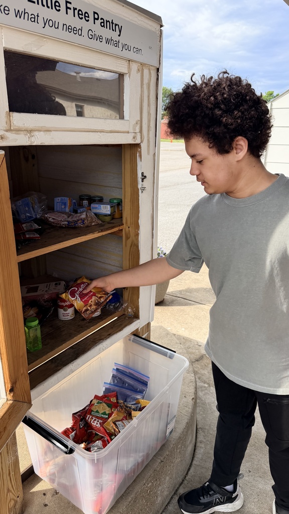 student stocking pantry
