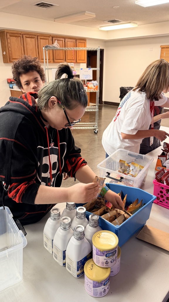 student stocking pantry