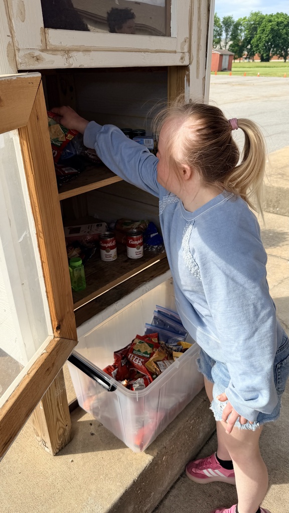 student stocking pantry