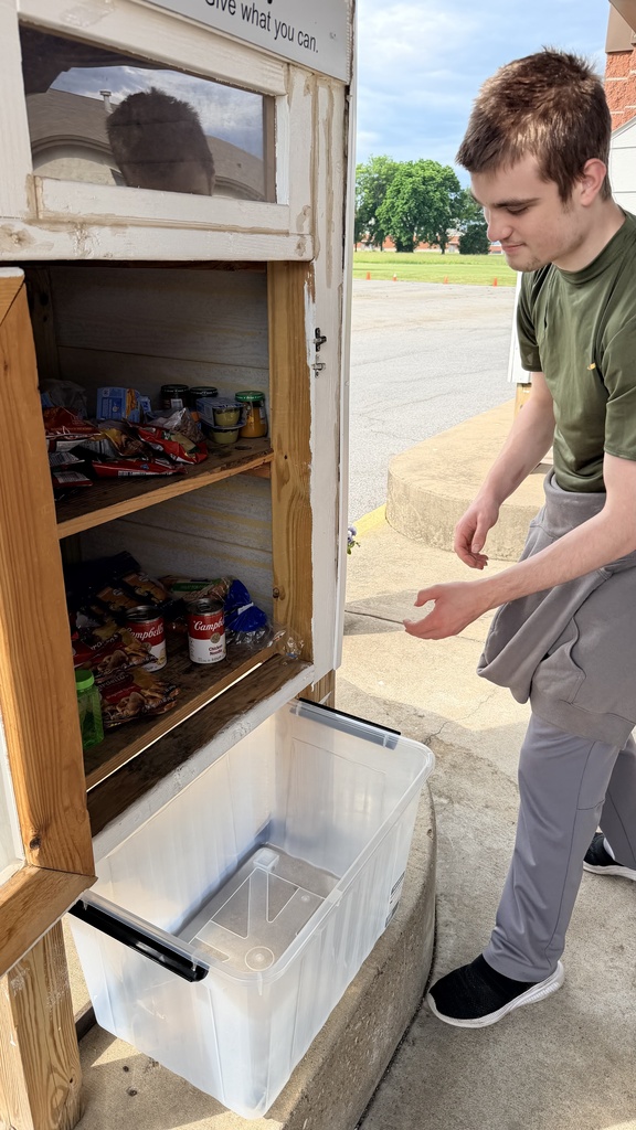 student stocking pantry