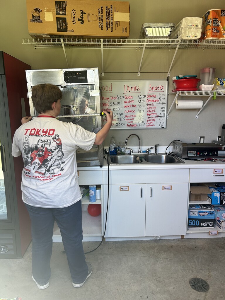 Student measuring the concession stand