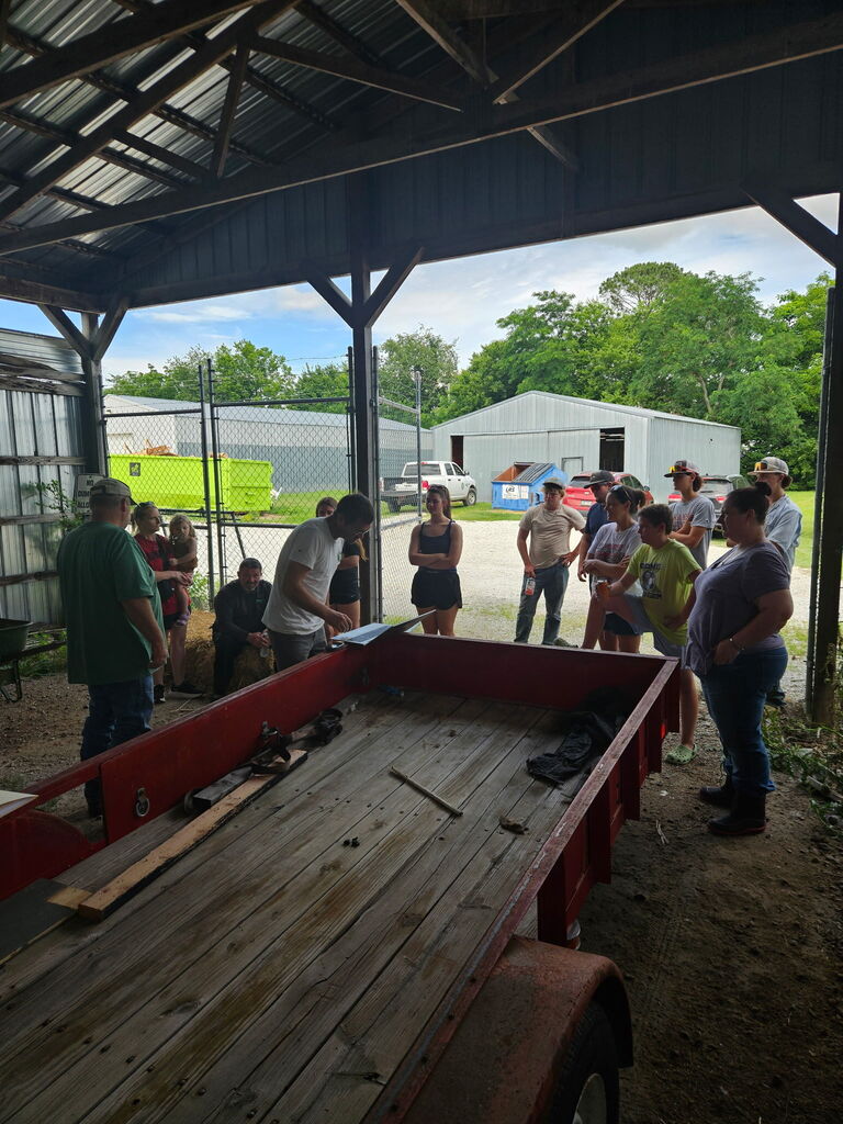 students listening to instructions in barn