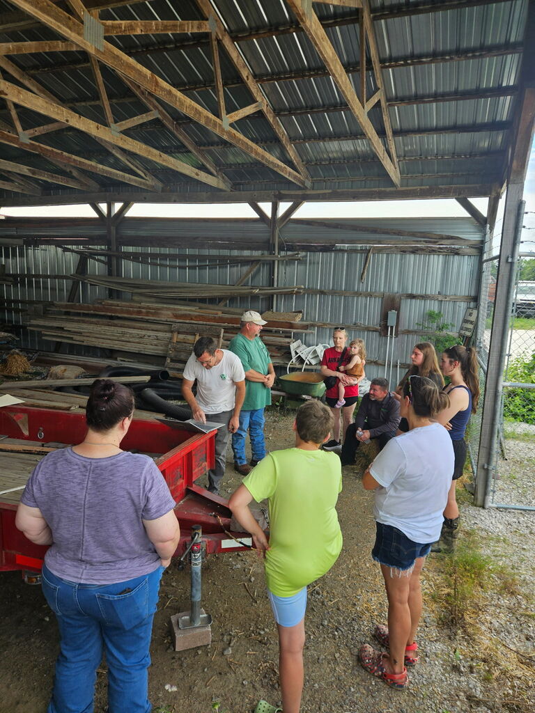 students listening to instructions in barn