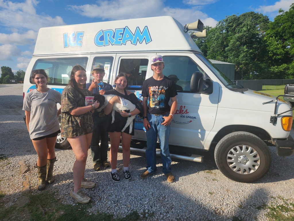 students posing with lamb and ice cream truck