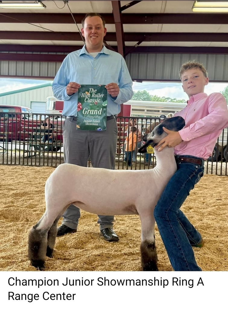 student posing with sheep
