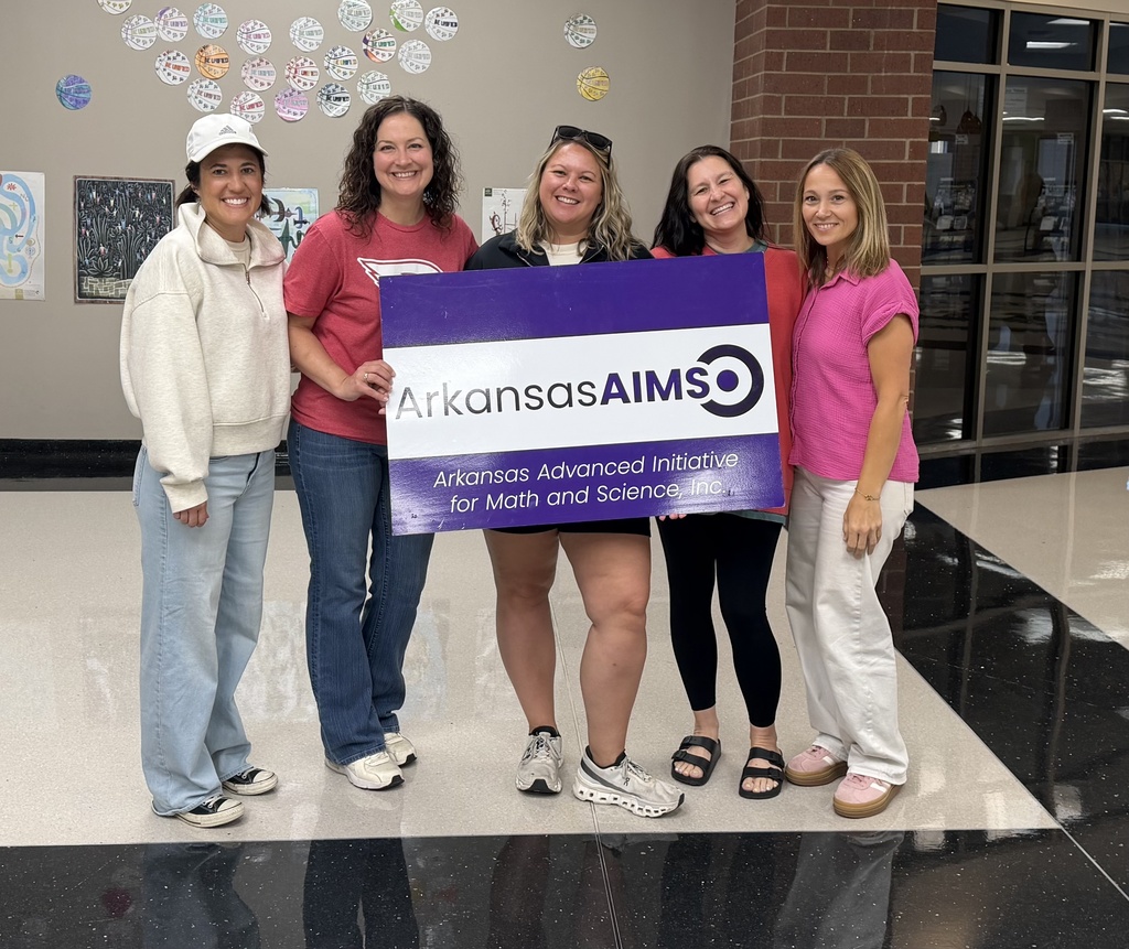 Teachers at Math PD, holding sign