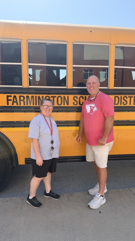 bus drivers posing in front of bus