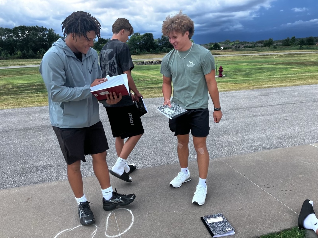 students writing a poem on the sidewalk in chalk