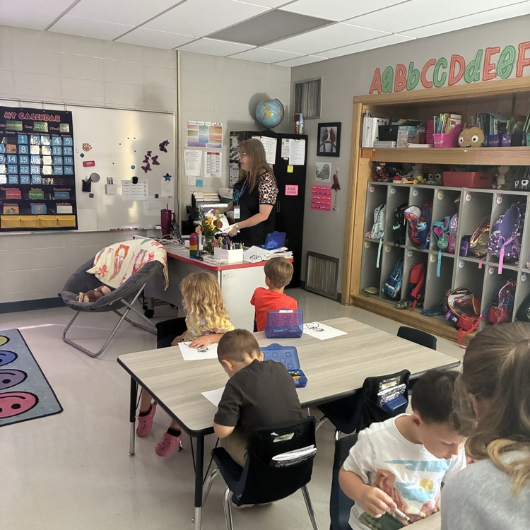 Mrs. Dooly modeling for the students  