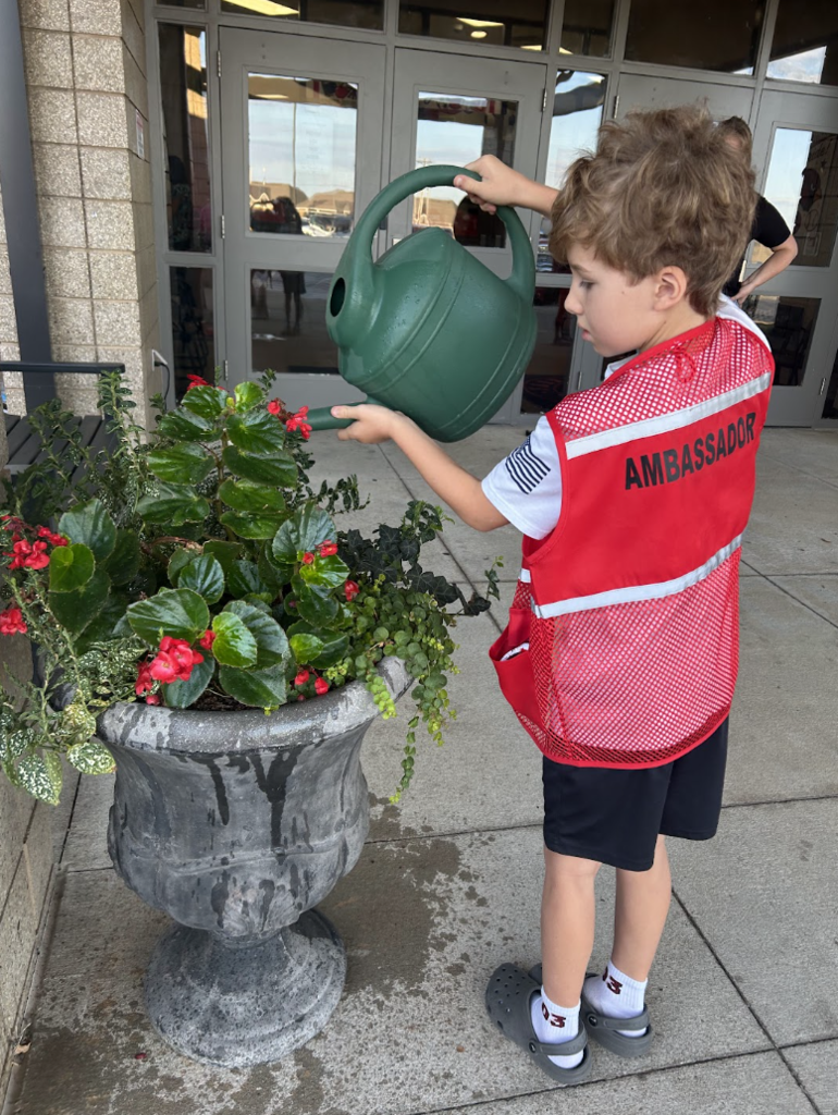 Ambassadors water the plants
