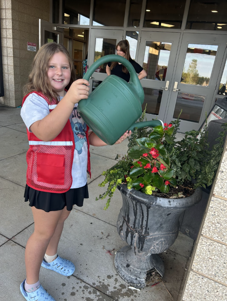Ambassadors water the plants