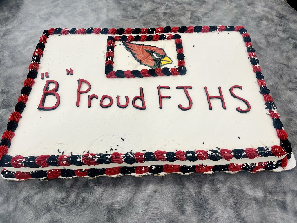 A cake with red, white, and blue icing. The words "B Proud FJHS" are written in red, and a cardinal is in a red box.