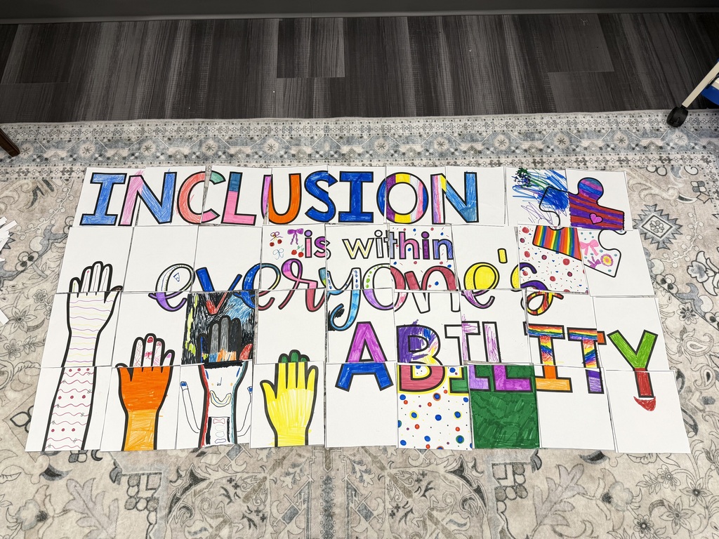 Mosaic artwork on floor. Words: "Inclusion Is Within Everyone's Ability". Various colored hands and drawings.