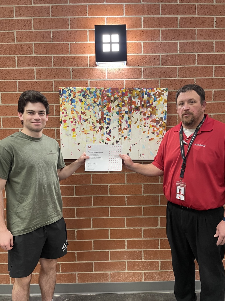 student posing with teacher and certificate