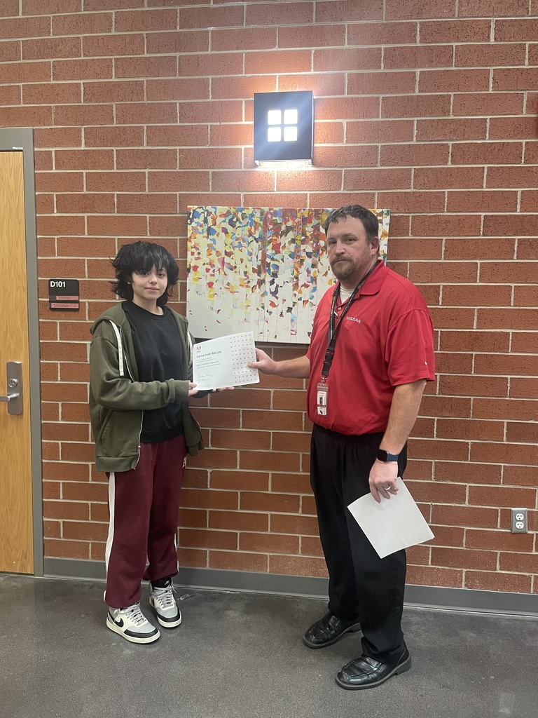 student posing with teacher and certificate