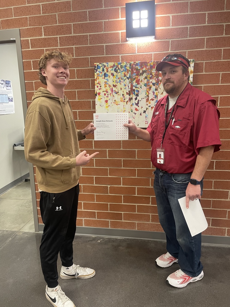student posing with teacher and certificate