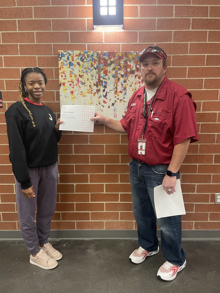 student posing with teacher and certificate 