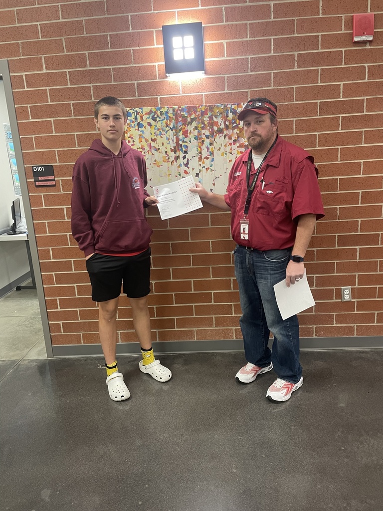 student posing with teacher and certificate