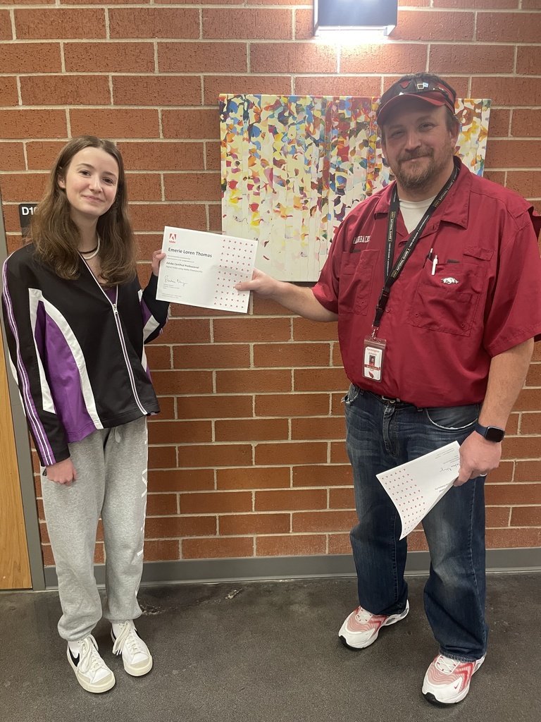 student posing with teacher and certificate