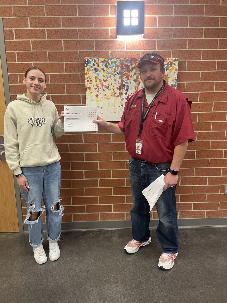 student posing with teacher and certificate