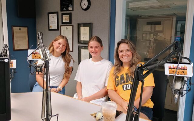 Three women with Farmington Cheer in KREI Radio studio