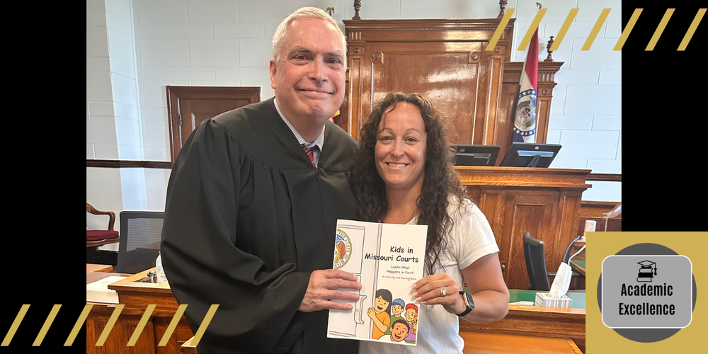 Keli Keutzer and Judge Patrick King with the children's book they had published