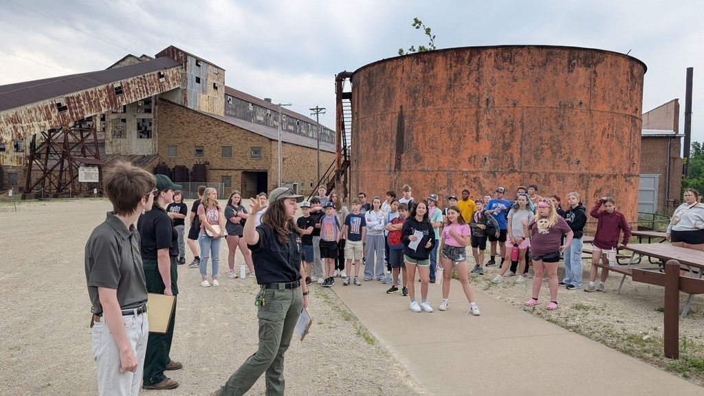 students getting instructions from tour leader outside mines