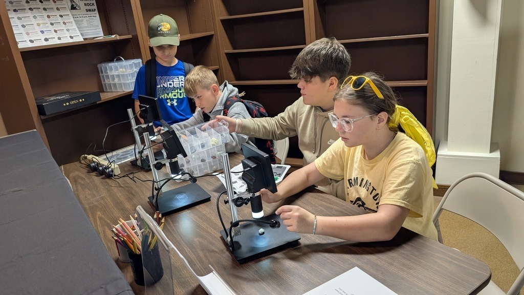 students using microscopes to look at minerals