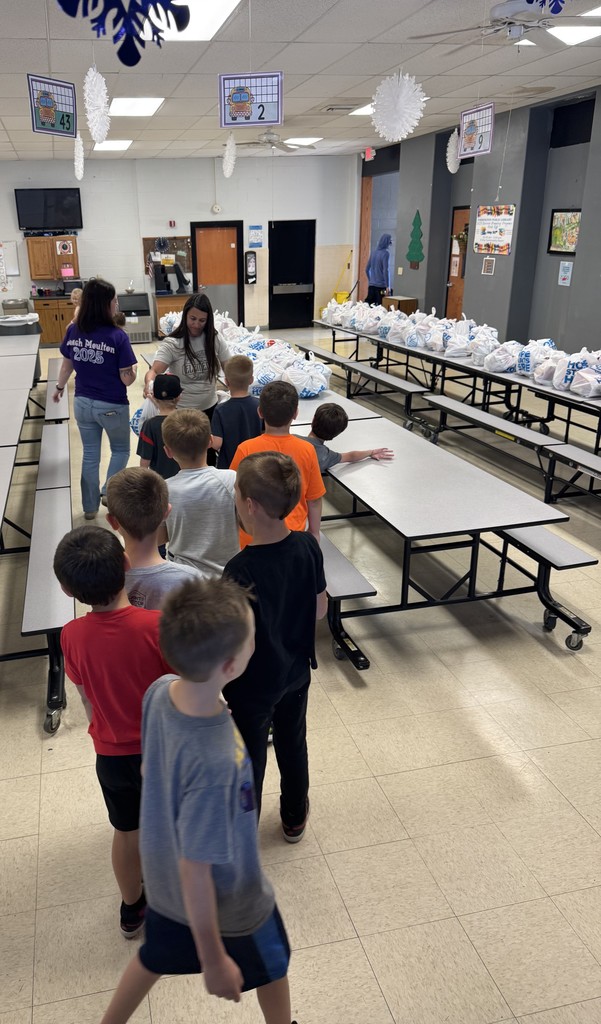 Students picking up food bags to take home