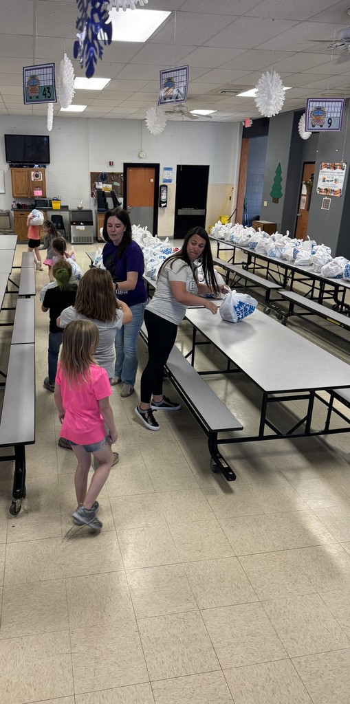 Students picking up food bags to take home