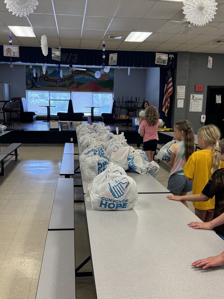 Students picking up food bags to take home