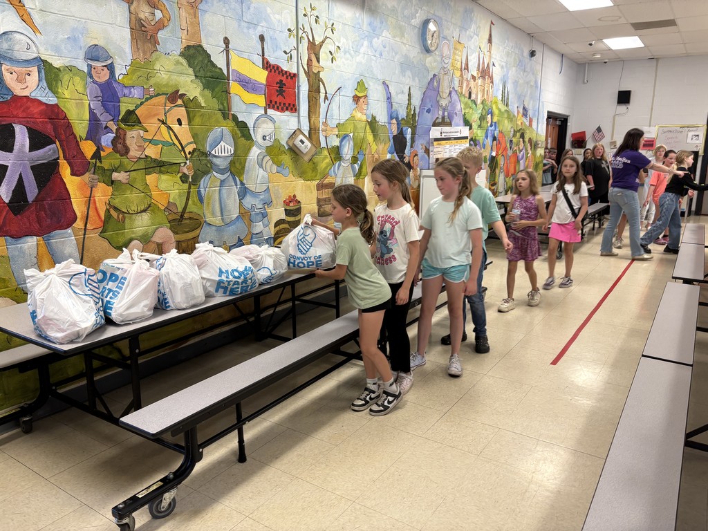 Students picking up food bags to take home