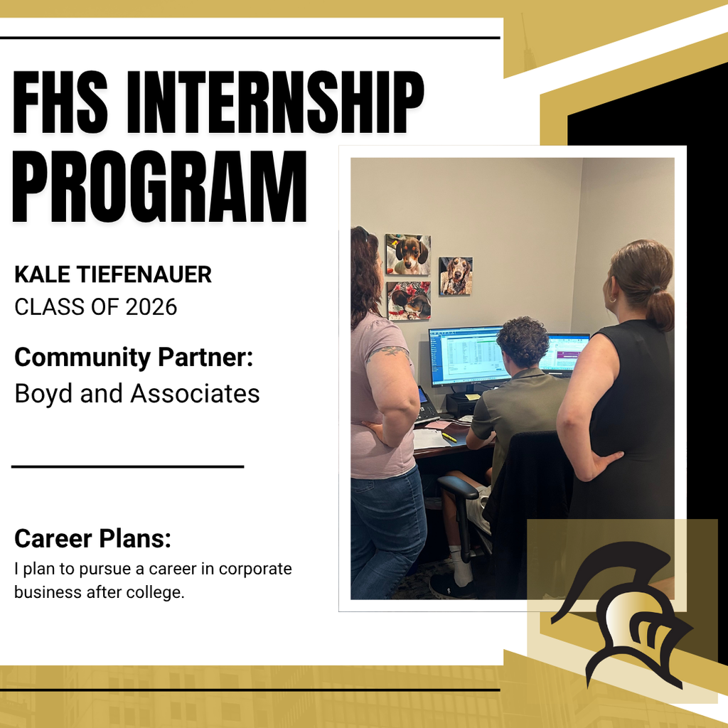 Kale at a computer with staff looking over his shoulder