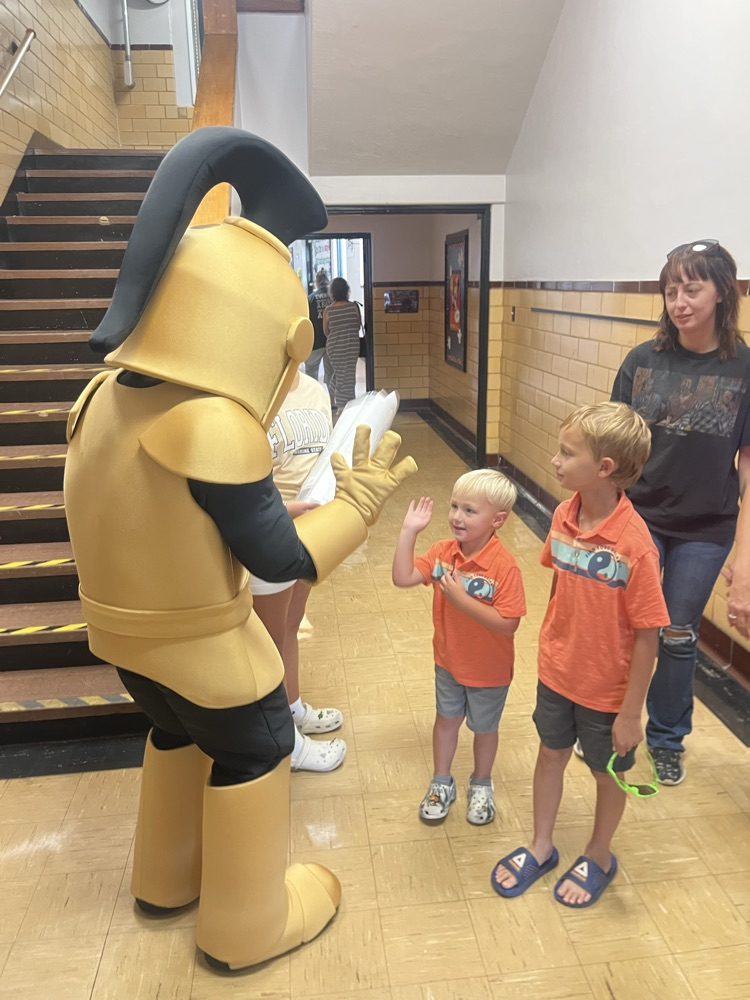 Knightro visiting with student at Open House!