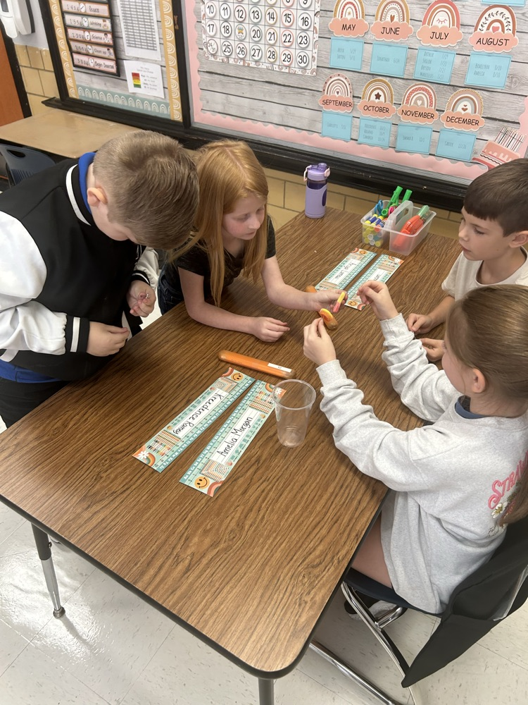 students working together to “save the worm”