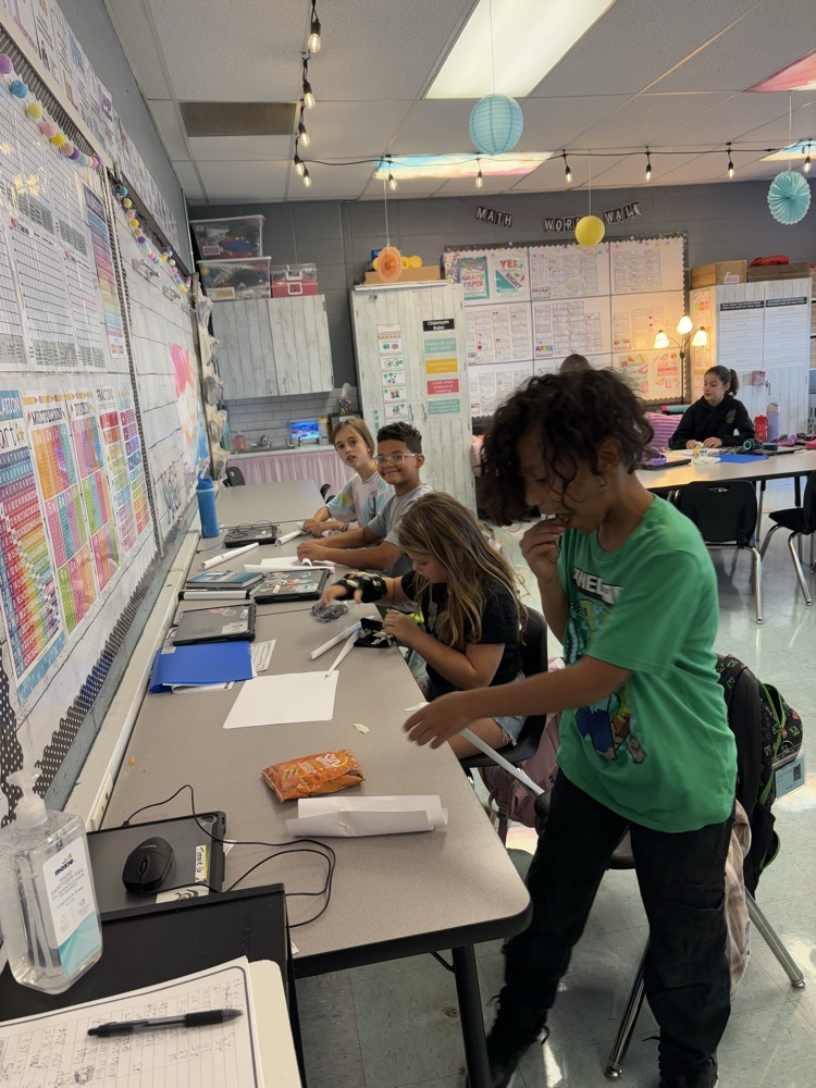 students building a structure to hold books